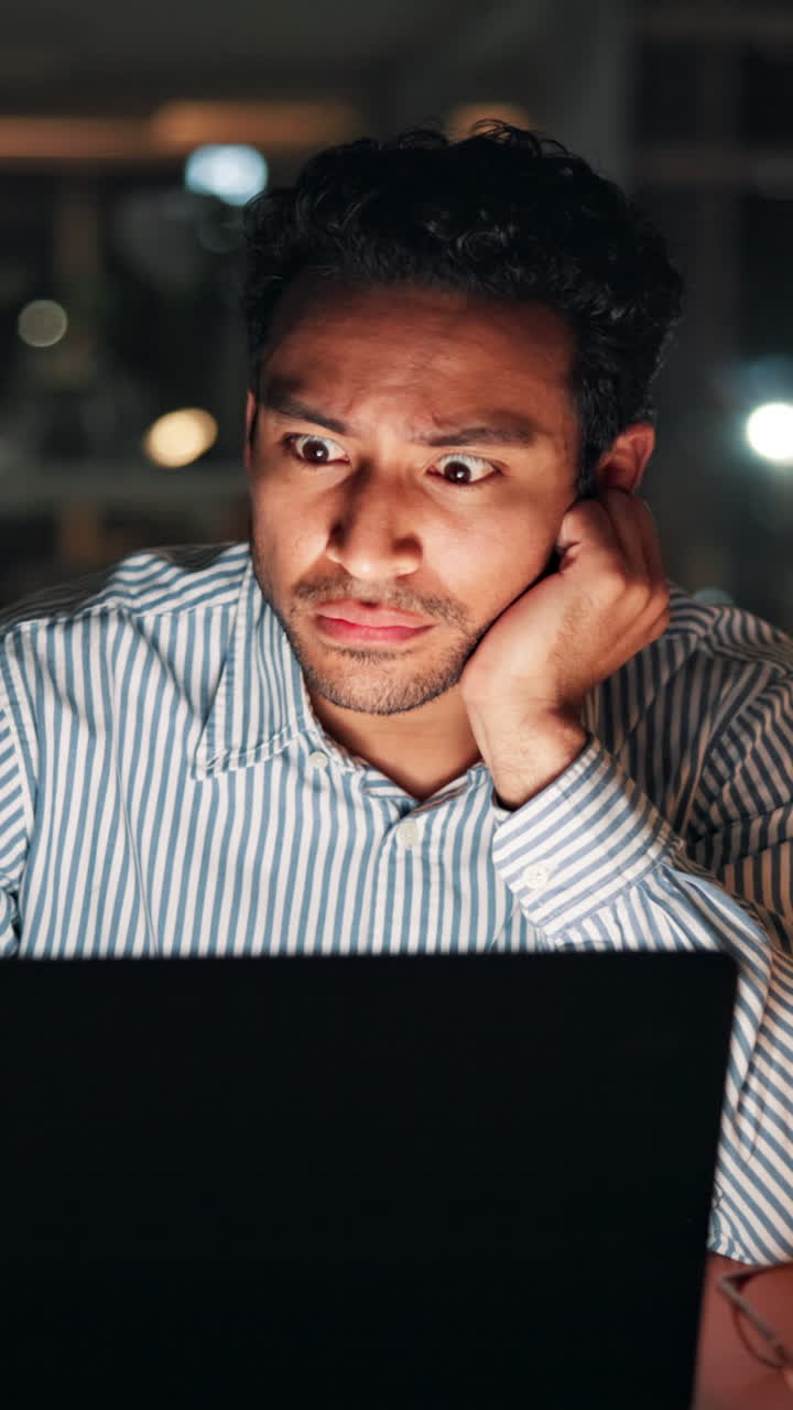 Tired Man Working Late on Laptop in Dark Office