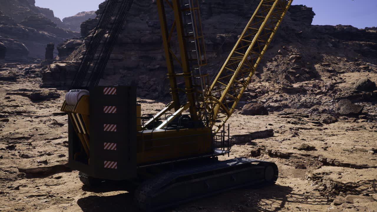 Heavy machinery operates on rugged terrain in remote landscape