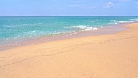 wide golden sandy beach and calm turquoise sea of tropical island paradise