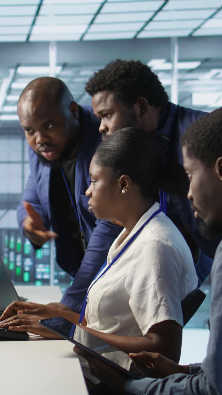 Vertical video Team of data center technicians maintaining company network infrastructure