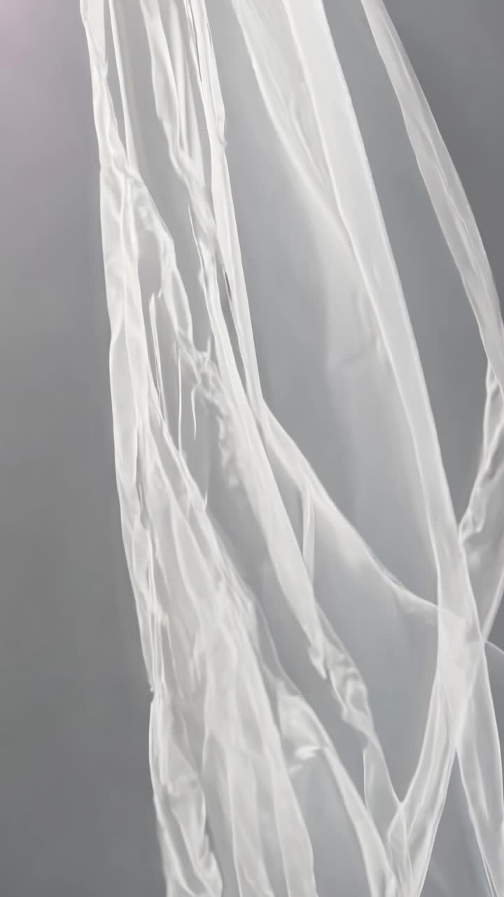 Elegant, flowing white fabric captured in a mid-angle shot, creating a serene and ethereal