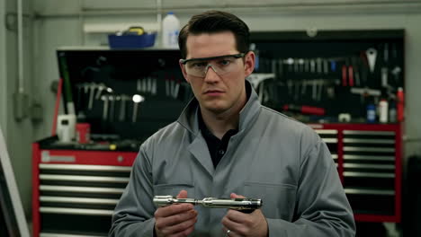 man in safety glasses in workshop