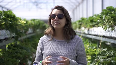 South-Asian-Woman-Wearing-Sunglasses-Walking-Through-A-Fruit-Farm