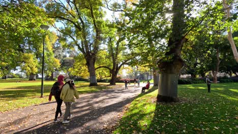 people strolling through a sunlit park