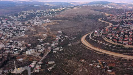 aerial view of settlements and terraced hillsides divided by a road