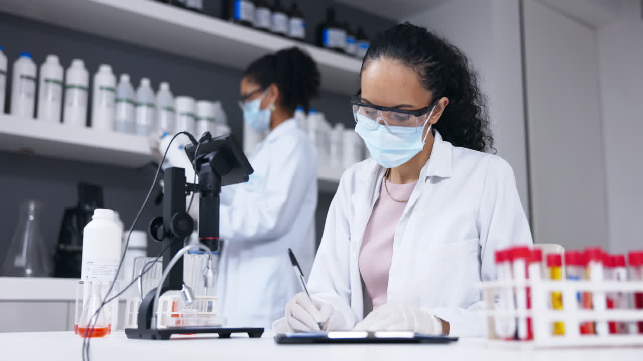 Scientist writing, covid clipboard
