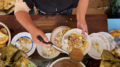 Local-Indonesian-chef-working-on-Kupat-Tahu-food,-top-down-view