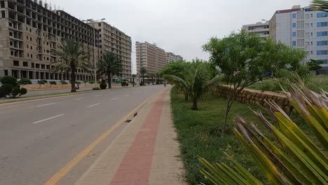 view along highway road beside developments at bahria housing development in karachi