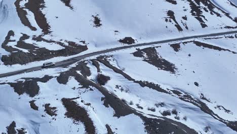 snowy mountain road with car