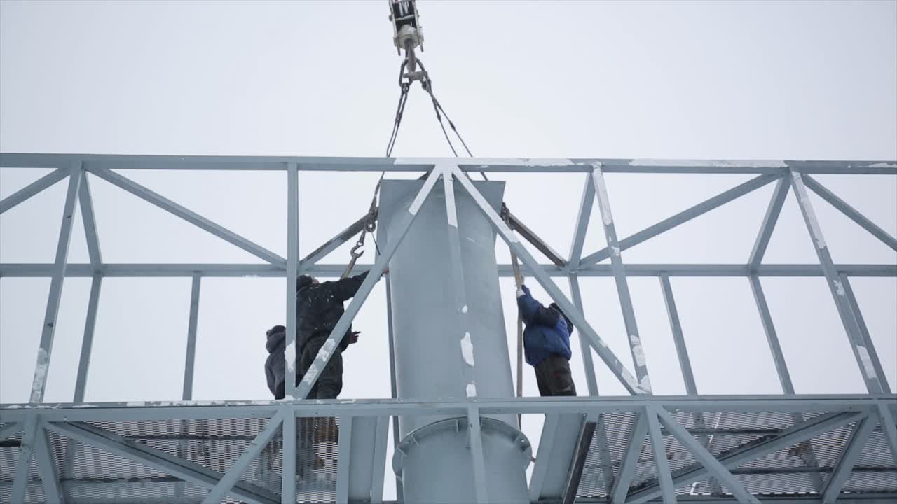 Construction Workers Installing Metal Structure