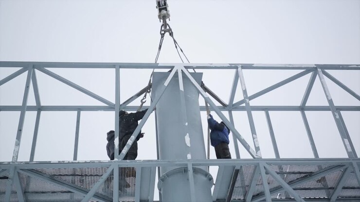 Construction Workers Installing Metal Structure
