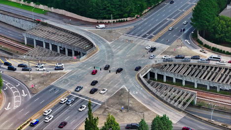 aerial top down of busy multi lane junction and tracks underpass in american town