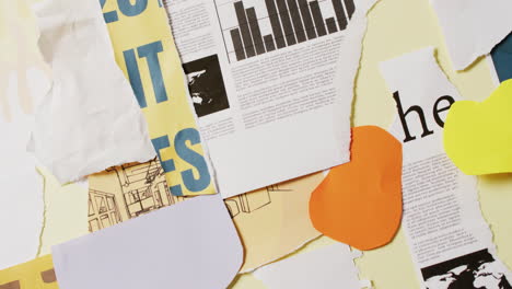 video de primer plano de un collage de trozos de papel y periódico sobre un fondo amarillo