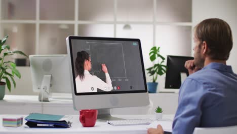 Caucasian-male-student-using-computer-on-video-call-with-female-teacher