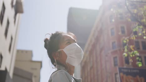 Mixed-race-woman-wearing-medical-coronavirus-mask-on-the-street