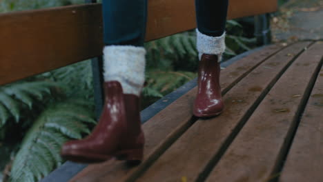 close up boots woman walking on wooden bridge in forest enjoying nature exploring calm winter day