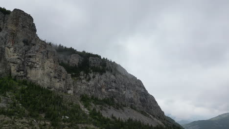 Berggipfel-Bedeckt-Mit-Immergrünen-Bäumen-An-Einem-Dunklen,-Bewölkten-Tag