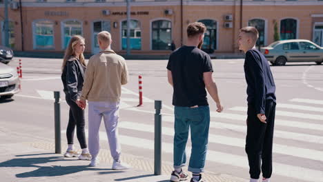 happy friends crosses the road. group of youth people crossing road on crosswalk