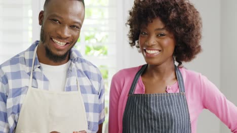 Happy-man-and-woman-preparing-juice-in-juicer