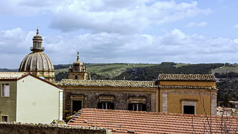 timelapse of the historic castello di ragusa ibla built in baroque architecture during a cultural trip through the sicilian city of ragusa, italy with moving clouds on a summer day