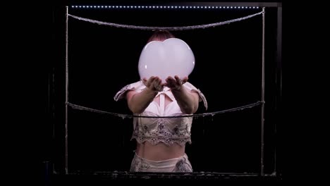 girl does tricks with soap bubbles. she takes two big bubbles with hands, then, shakes them off