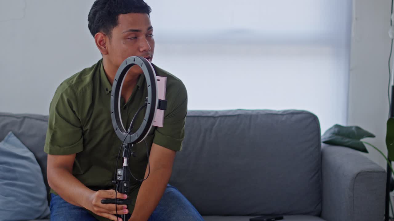 Innholdsskaper som filmer med smarttelefon blir avbrutt av et takproblem mens hun sitter i sofaen.