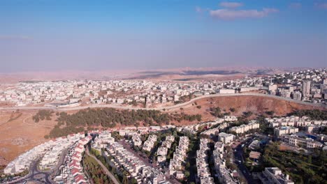 Aerial View of a City and Separation Barrier in Arid Landscape