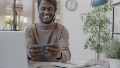 man using smartphone in the office