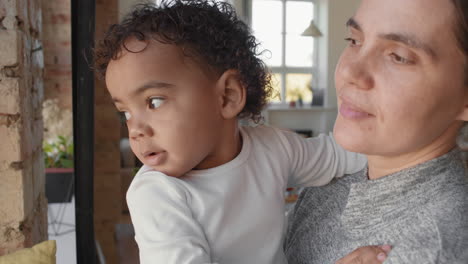 close up of mother and toddler looking out window