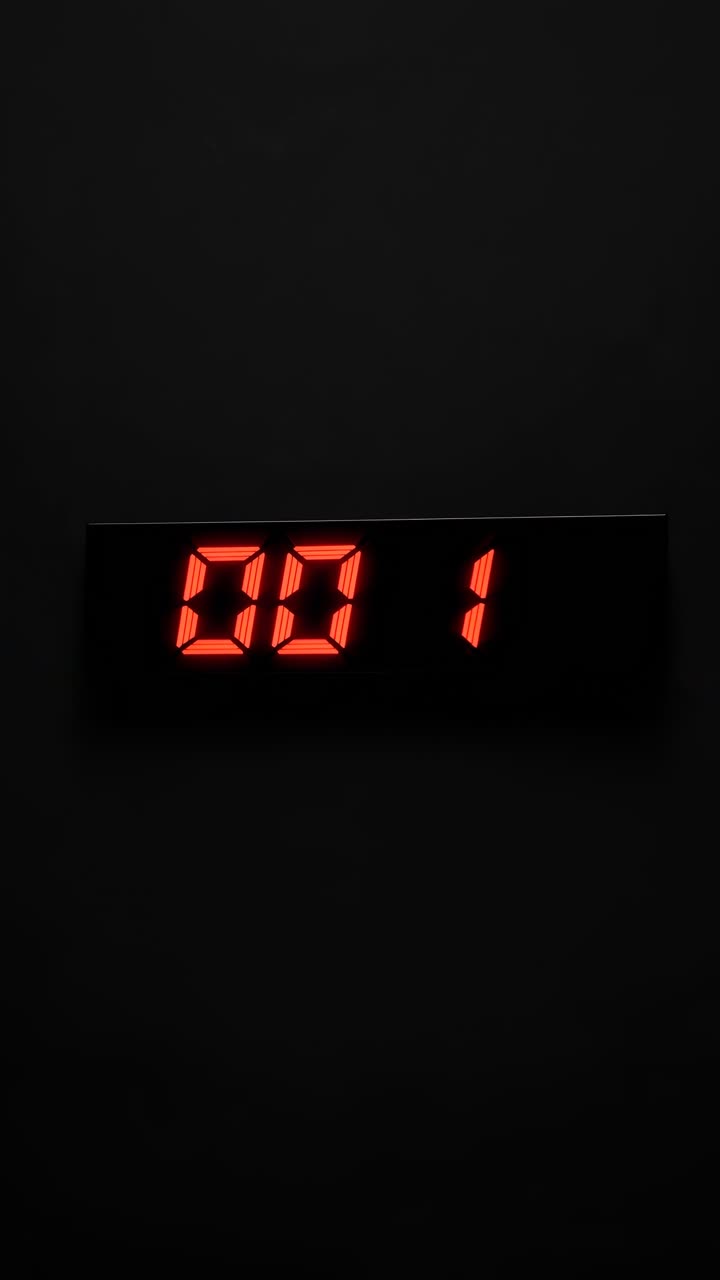 Minimalist video concept featuring a digital timer with red numbers on a black background