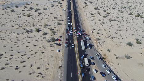 view of a drone flying forward showing a manifestation in the middle of the highway