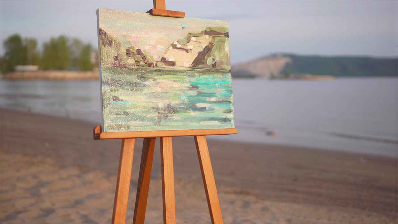 Painting of a River Landscape on an Easel at the Beach