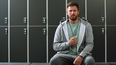 man sitting in locker room