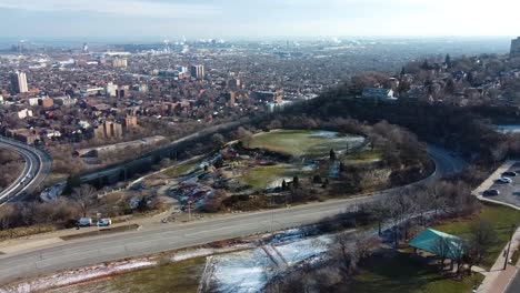 Drone-flying-over-highway-in-the-winter-in-Hamilton,-Ontario