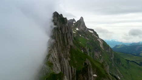 cinematic rotating drone shot starting in the clouds then revealing altenalp turm in switzerland