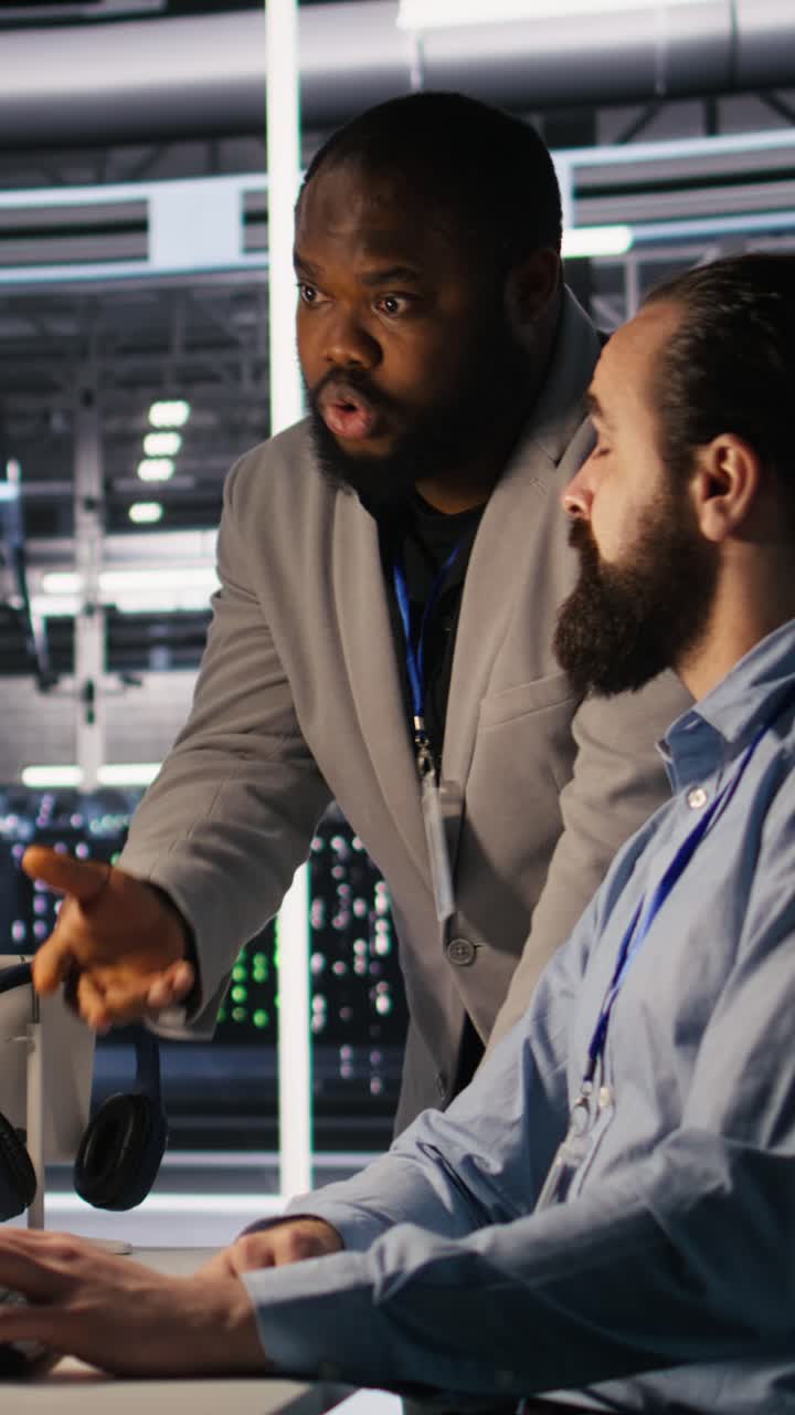 Vertical video Supervisor in server room monitoring worker managing AI training datasets