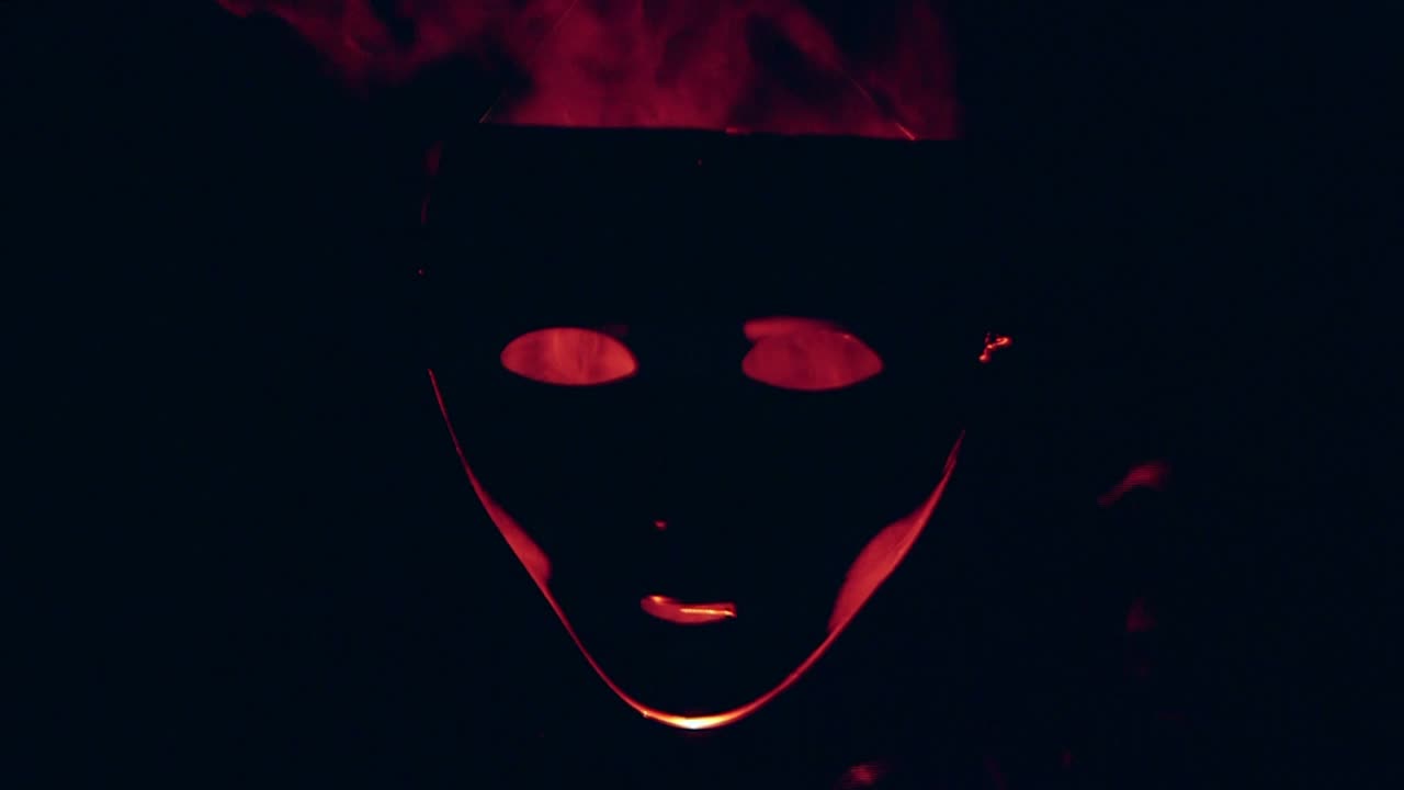 Human mask in the red fire