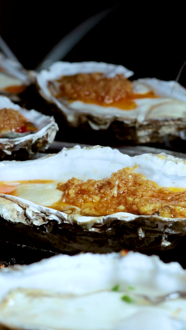 Oysters being grilled at a street food stall