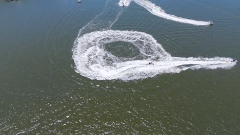 jet skis creating circular patterns on water surface