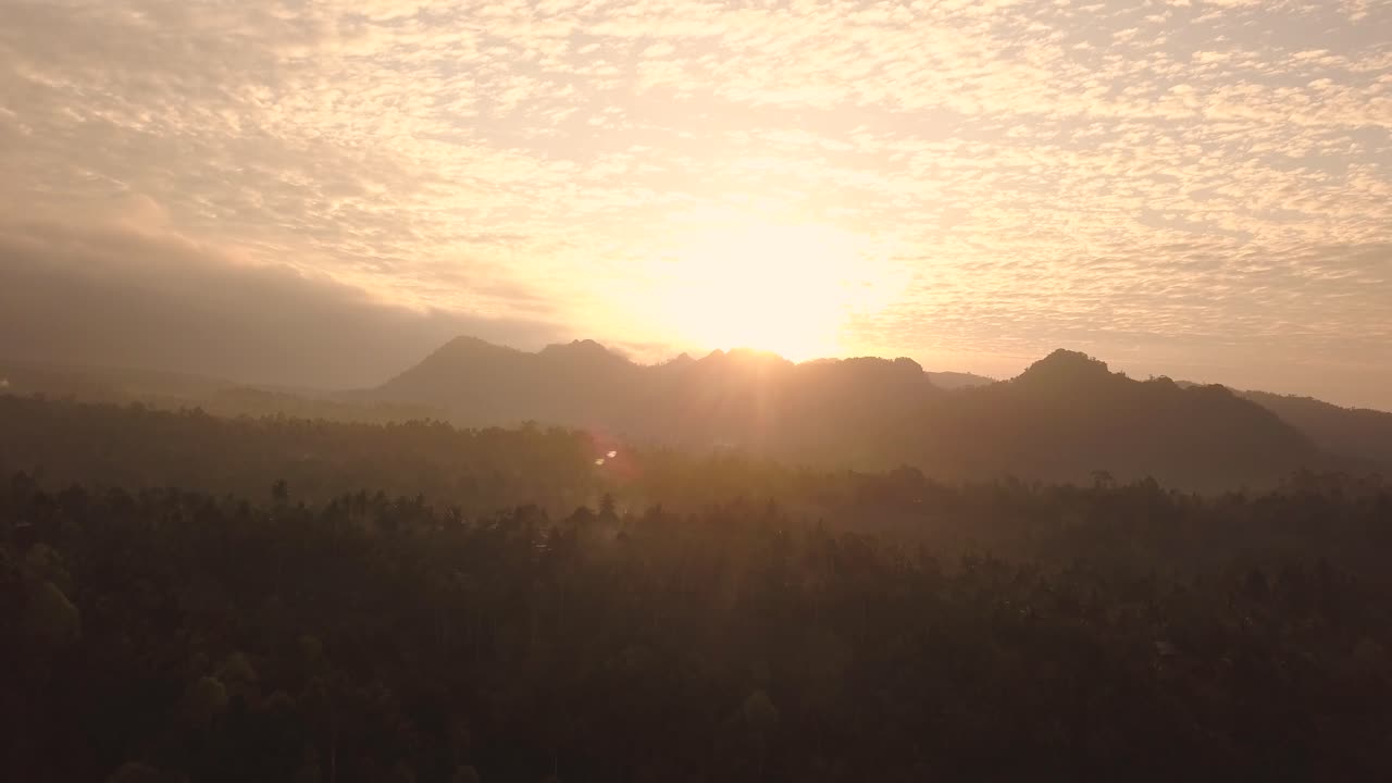 Tropical landscape at sunset. Java Island. Indonesia. Aerial forward