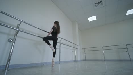 young ballerina practicing dance moves in studio