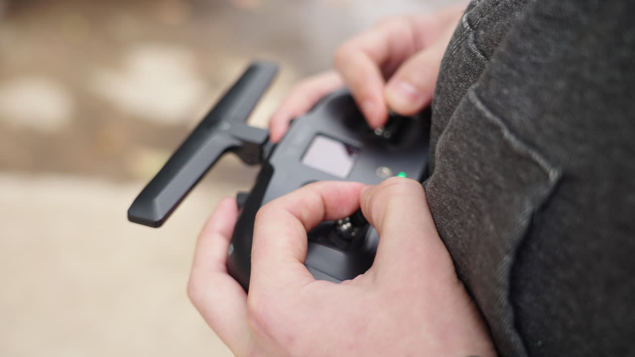Close-up of Hands Operating a Drone Remote Controller