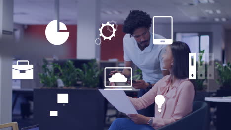 Business icons animation over colleagues discussing documents in modern office