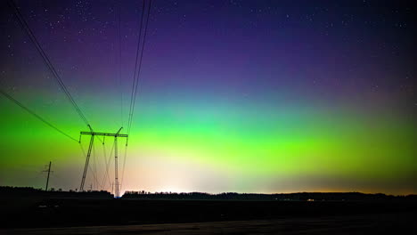 Cloudy-geomagnetic-storm-sky-on-top-of-electric-wires-in-rural-nature---Time-lapse