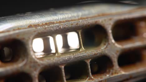 close-up examination of metal texture and structure with visible light shine through openings in a rusted component