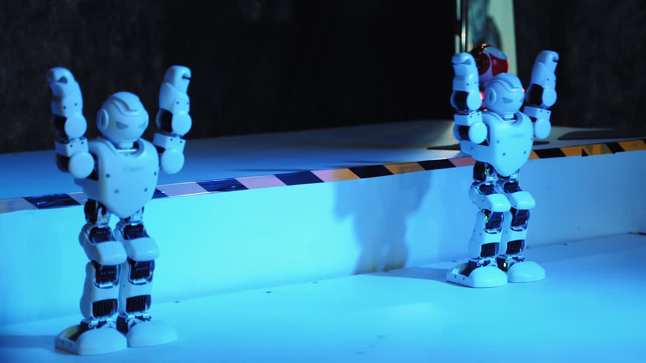 Humanoid robot dance. Group of cute robots dancing. Close up of smart robot dance show. Dancing robot performance. Robotic dance party. Smart robotic technology