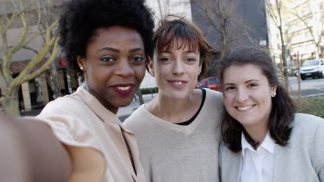 group of cheerful women talking during video call