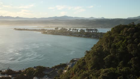 golden hour view from knysna heads overlooking leisure isle and misty mountains
