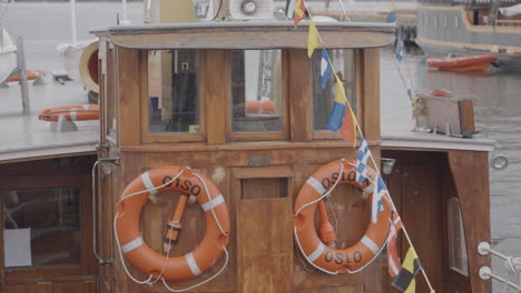 wooden boat deck with life preservers and flags