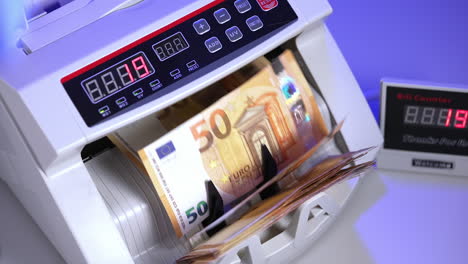 financial money currency counting machine. close up of euro banknotes while counting.
